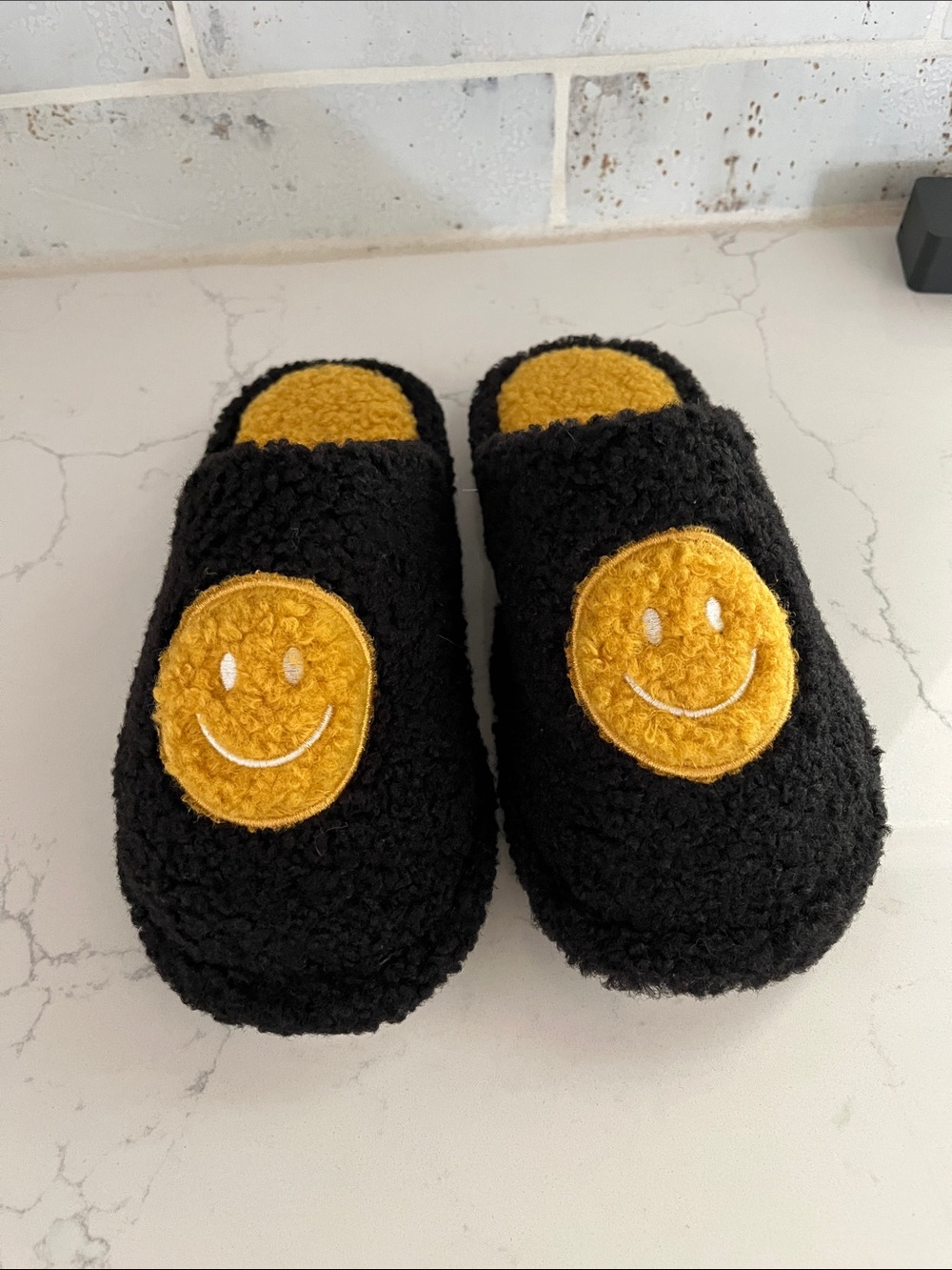 Cozy Black Fuzzy Slippers with Yellow Smiley Accent